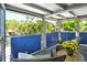 Cozy covered porch featuring wicker furniture, a round table, and peaceful views of the surrounding landscape at 433 N Osprey Ave, Sarasota, FL 34236
