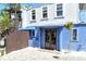 Inviting entrance to a cottage with a charming blue facade and wooden accents at 433 N Osprey Ave, Sarasota, FL 34236