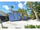 Charming cottage with a second-floor deck and private yard surrounded by palm trees at 433 N Osprey Ave, Sarasota, FL 34236