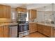 Updated kitchen featuring stainless steel appliances, warm wood cabinetry and breakfast bar at 433 N Osprey Ave, Sarasota, FL 34236
