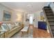 Comfortable living room with hardwood floors, stairs to the upper floor and entrance to the kitchen at 433 N Osprey Ave, Sarasota, FL 34236