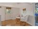 Bright living room with hardwood floors, white wicker chairs, and access to porch at 433 N Osprey Ave, Sarasota, FL 34236