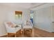 Cozy sitting room with white wicker chairs, wood floors, and natural light at 433 N Osprey Ave, Sarasota, FL 34236