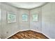 Bright room featuring three windows and hardwood floors at 433 N Osprey Ave, Sarasota, FL 34236