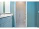Bright bathroom area with toilet stall, white cabinets, and tile flooring at 4341 Callista Ln, Sarasota, FL 34243
