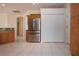 Kitchen featuring stainless steel refrigerator, granite counters, tile floors and adjacent pantry closet at 4341 Callista Ln, Sarasota, FL 34243
