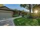 Beautiful home showcasing lush landscaping, brick accents, and a paved walkway to the front door at 4445 Oak View Dr, Sarasota, FL 34232