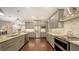 Spacious kitchen features stainless steel appliances, granite countertops, and gray cabinets at 4445 Oak View Dr, Sarasota, FL 34232