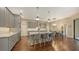 Stylish kitchen with a center island, bar stools, stainless steel appliances, and open dining area at 4445 Oak View Dr, Sarasota, FL 34232