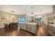 Open-concept kitchen and dining area leading to a screened-in pool and living room at 4445 Oak View Dr, Sarasota, FL 34232