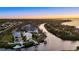 Stunning aerial view of waterfront homes, docks, and a canal at sunset at 4607 5Th Ne Ave, Bradenton, FL 34208
