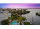 Aerial view of waterfront home with a pool, dock, and lush tropical landscaping at 4607 5Th Ne Ave, Bradenton, FL 34208