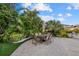 Charming backyard patio with dining set, lush tropical landscaping, and serene outdoor space for entertaining guests at 4607 5Th Ne Ave, Bradenton, FL 34208