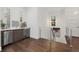 Second floor wet bar boasts hardwood floors, stainless steel appliances, and a unique tile backsplash at 4607 5Th Ne Ave, Bradenton, FL 34208
