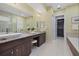 Bright bathroom with dual sinks, granite counters, and walk-in closet at 4607 5Th Ne Ave, Bradenton, FL 34208