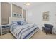 Stylishly decorated bedroom with coastal decor, a white bed frame, and coordinated blue accents at 4607 5Th Ne Ave, Bradenton, FL 34208