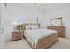 Bright bedroom with a wood frame bed, white walls, shutters, and a wood dresser with mirror at 4607 5Th Ne Ave, Bradenton, FL 34208