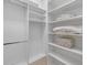 A walk-in closet featuring white shelves, storage, and ample space for organization at 4607 5Th Ne Ave, Bradenton, FL 34208