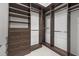 A spacious walk-in closet features dark wood shelving and drawers providing ample storage space at 4607 5Th Ne Ave, Bradenton, FL 34208