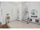 Inviting foyer with tile flooring, white walls, a staircase to the second floor, and elegant decor at 4607 5Th Ne Ave, Bradenton, FL 34208