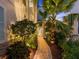 Landscaped walkway leading to the front entrance of the home, surrounded by lush tropical foliage at 4607 5Th Ne Ave, Bradenton, FL 34208