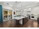 Modern kitchen features a large island with a quartz countertop, stainless steel appliances, and an open floorplan at 4607 5Th Ne Ave, Bradenton, FL 34208