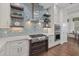 Bright kitchen boasts stainless steel appliances, double ovens, mosaic tile backsplash, custom cabinetry and hardwood floors at 4607 5Th Ne Ave, Bradenton, FL 34208