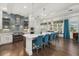 Modern kitchen with an island, blue backsplash, stainless steel appliances, and hardwood floors at 4607 5Th Ne Ave, Bradenton, FL 34208
