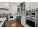 Bright kitchen boasts stainless steel appliances, double ovens, mosaic tile backsplash, custom cabinetry and hardwood floors at 4607 5Th Ne Ave, Bradenton, FL 34208