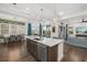 Bright kitchen has an island with seating, stainless steel appliances, eat in dining area, and an open concept at 4607 5Th Ne Ave, Bradenton, FL 34208
