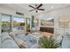 Relaxing living room featuring a tv and view of the pool area, complete with sliding glass doors at 4607 5Th Ne Ave, Bradenton, FL 34208