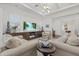 Bright living room features coffered ceilings, beach-themed decor, and modern media center at 4607 5Th Ne Ave, Bradenton, FL 34208