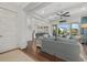 Bright living room featuring hardwood floors, a ceiling fan, and views of the outdoor pool area at 4607 5Th Ne Ave, Bradenton, FL 34208