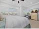 Bright main bedroom with a ceiling fan, plantation shutters and television at 4607 5Th Ne Ave, Bradenton, FL 34208