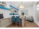Bright office features a custom desk with blue accents, an accent chair, and hardwood floors at 4607 5Th Ne Ave, Bradenton, FL 34208