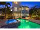 Inviting backyard pool and spa with a brick patio and lush tropical landscaping at 4607 5Th Ne Ave, Bradenton, FL 34208