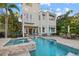 Stunning backyard with a luxurious pool, spa, and outdoor dining area perfect for entertaining guests at 4607 5Th Ne Ave, Bradenton, FL 34208