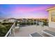 Waterfront rooftop deck offers stunning views with modern railings and comfortable lounge seating to enjoy the sunset at 4607 5Th Ne Ave, Bradenton, FL 34208