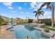 Stunning backyard pool and spa with lush landscaping, complemented by comfortable seating and clear blue skies at 4607 5Th Ne Ave, Bradenton, FL 34208