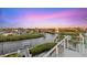 Beautiful waterfront view of luxury homes and boat docks, framed by a modern balcony with clear railings at 4607 5Th Ne Ave, Bradenton, FL 34208
