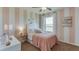Stylized bedroom with pink striped walls, neutral carpet, ceiling fan, and decorative lighting at 4607 Dusky Dawn Ln, Palmetto, FL 34221