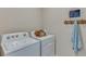 Laundry room featuring a modern washer and dryer set with a towel rack and laundry sign at 4607 Dusky Dawn Ln, Palmetto, FL 34221