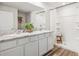 A bright bathroom with double sinks, sleek vanity, and a glass-enclosed shower at 4611 Dusky Dawn Ln, Palmetto, FL 34221