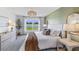 A bright main bedroom, featuring an accent wall, large window, and well-coordinated decor at 4611 Dusky Dawn Ln, Palmetto, FL 34221