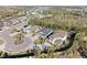 Aerial view of several homes in residential neighborhood, featuring mature trees and proximity to a lake at 4611 Los Robles Ct, Palmetto, FL 34221
