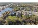 Stunning aerial view showcasing a well-maintained neighborhood with lush greenery and a picturesque lake at 4611 Los Robles Ct, Palmetto, FL 34221