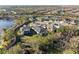 Aerial view of homes in a quiet neighborhood with mature trees and water features at 4611 Los Robles Ct, Palmetto, FL 34221