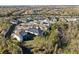 Expansive aerial view of a peaceful residential neighborhood featuring a lake, lush trees, and manicured lawns at 4611 Los Robles Ct, Palmetto, FL 34221