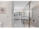 A view into the primary bathroom reveals a bathtub, a tiled shower with glass doors, and double sinks at 4611 Los Robles Ct, Palmetto, FL 34221