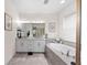 This bathroom features double sinks, a large soaking tub, and a tiled shower behind a glass enclosure at 4611 Los Robles Ct, Palmetto, FL 34221
